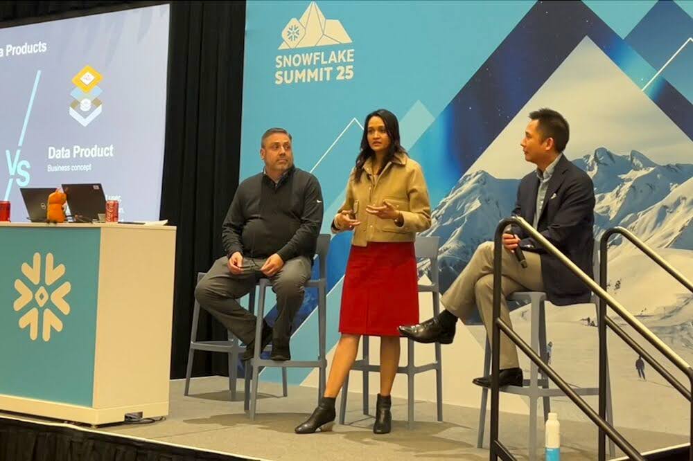 Photo of data leader Bharathi Rajan presenting on stage at Snowflake Summit 2025 on Swire Coca Cola's data journey with Alation CMO David Chao and Gordon Bonzo, Manager of Enterprise Master Data at Swire