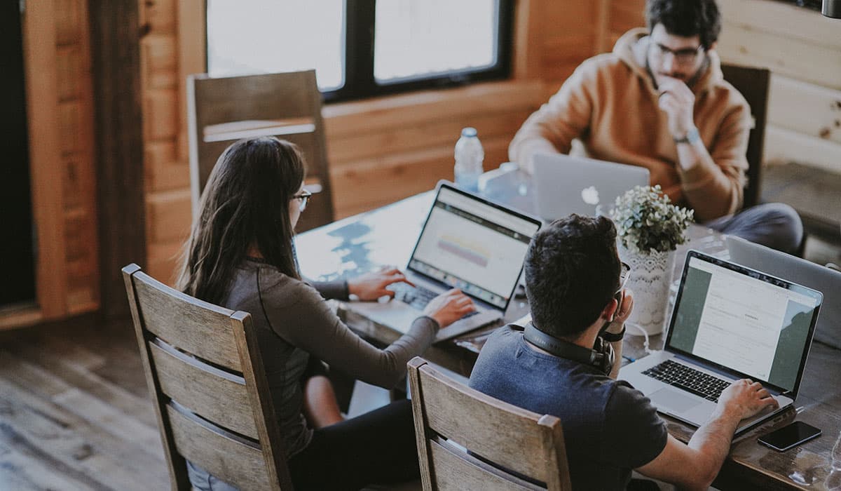 A group of three young students learning real-word data skills from Alation's Data Intelligence Project