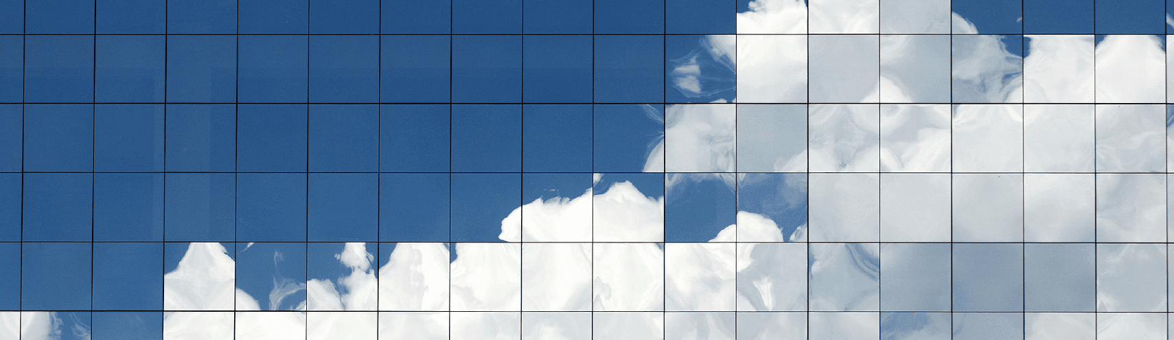 Mirror reflection of clouds within the outside of a building