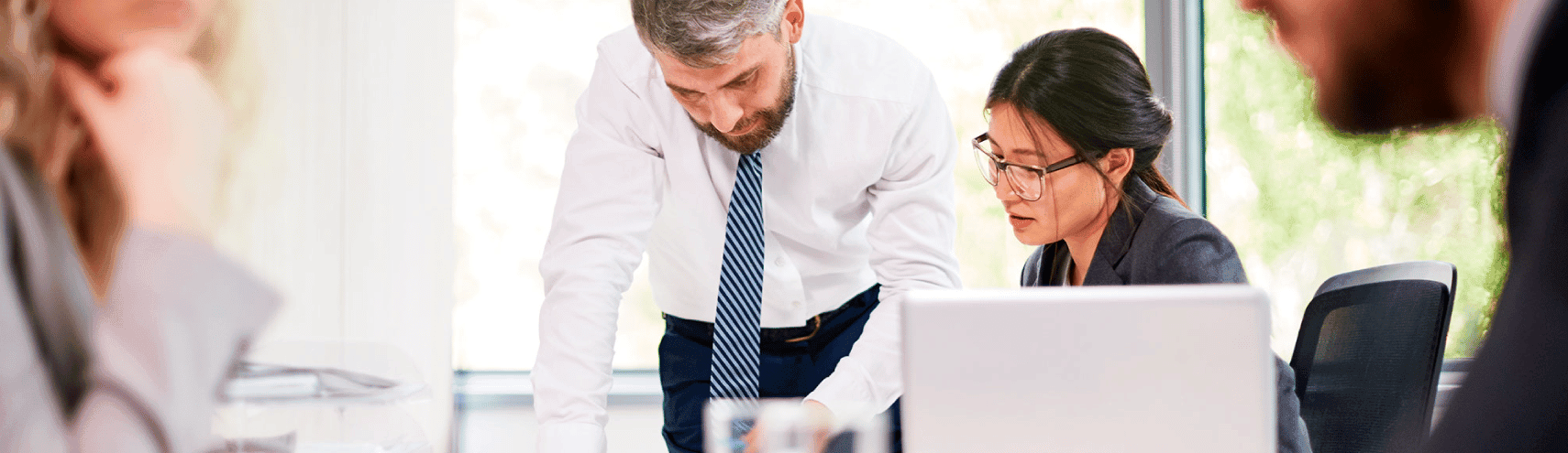 An office view with the focus on two colleagues working together in a business setting