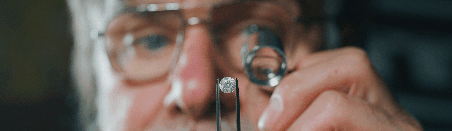Alation Blog Image: An older man looking into a diamond as a representation of analyzing data quality