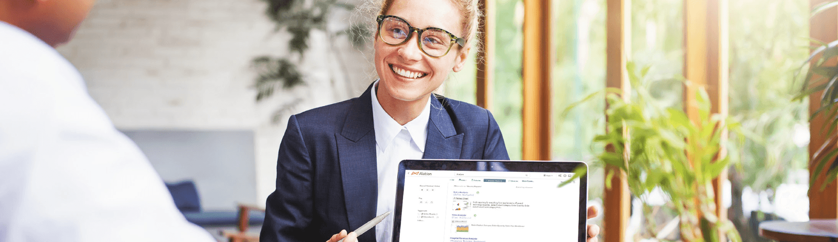 Alaiton image: A Data Product Manager smiling as she shared her laptop screen with a colleague.