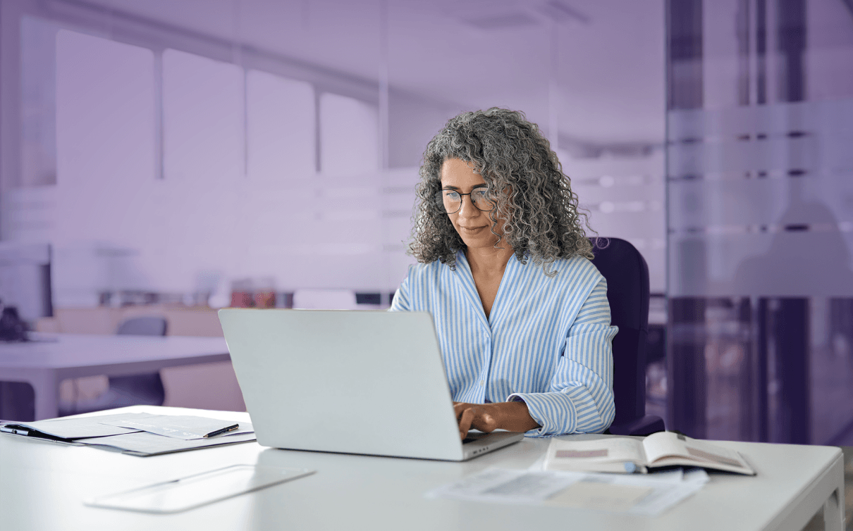 Hero image of the Alation privacy, risk, and compliance solution page showing woman on laptop