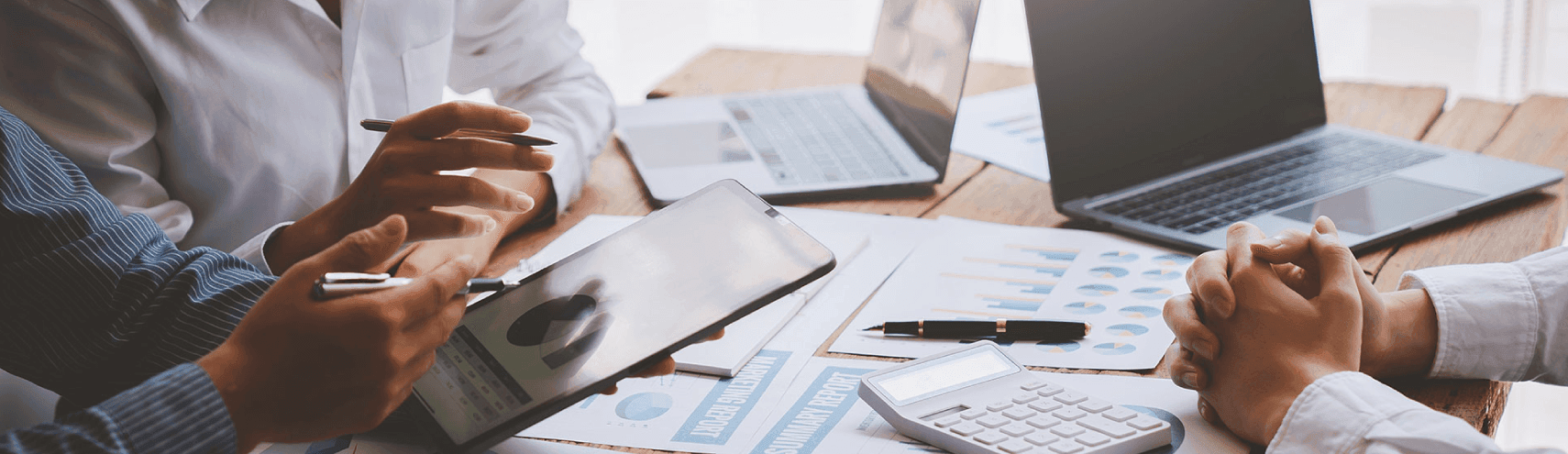 Alation Blog Image: Data scientists and data analysts collaborating in a office as they read about Alation's latest release, Alation 2023.1.