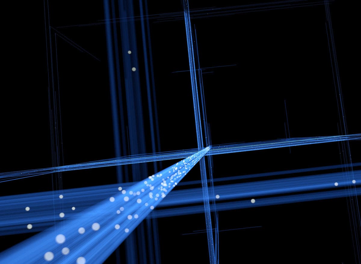 Abstract digital art featuring glowing blue light beams and white particles converging on a dark black background.